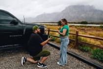 Eddie Hernandez, left, proposes to his girlfriend, Janette Espejo, while at a lookout point in ...