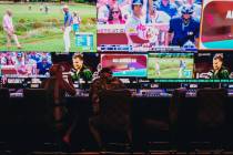 People sit at gambling machines in front of the Circa Sportsbook at Circa Las Vegas on Friday, ...