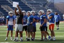 Bishop Gorman players read strategy during football practice at Bishop Gorman High School on We ...