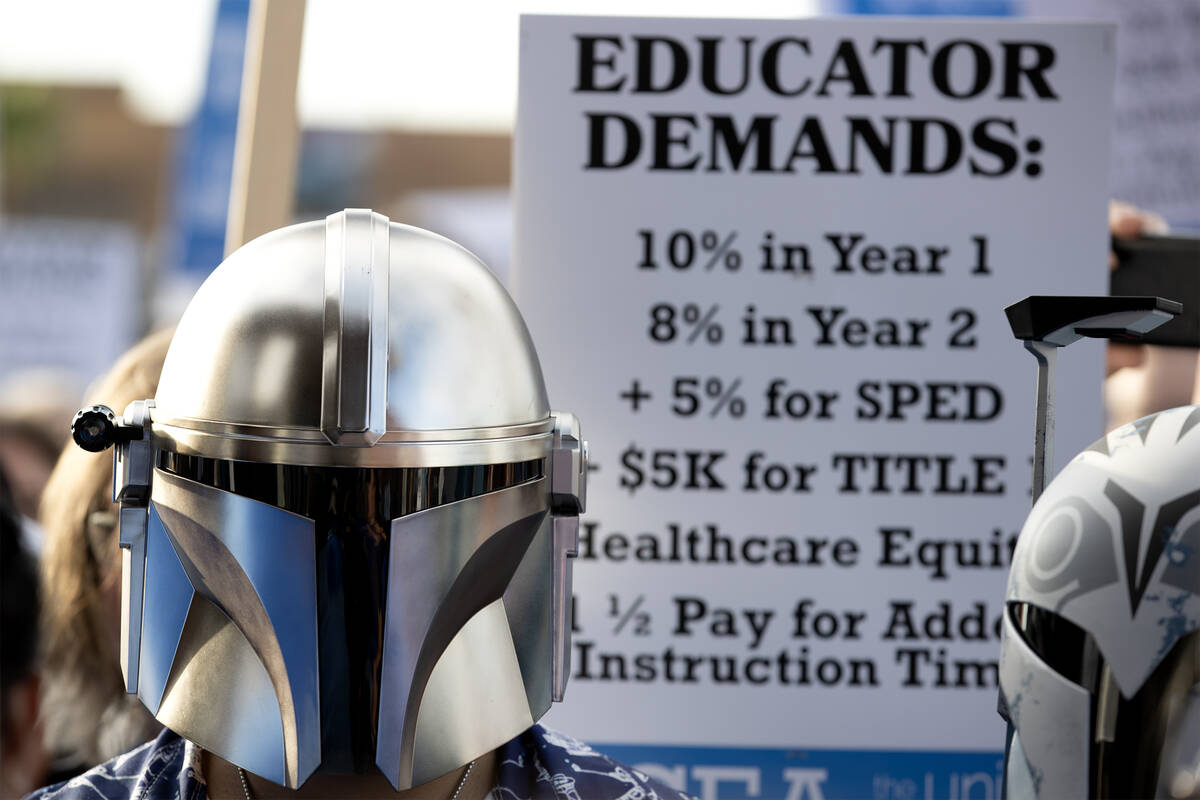 A protestor wears a Darth Vader mask while Clark County Education Association teachers union me ...