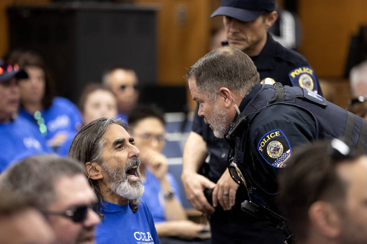 Aramis Bacallao, a teacher at Ernest A. Becker Middle School, shouts while a police officer att ...