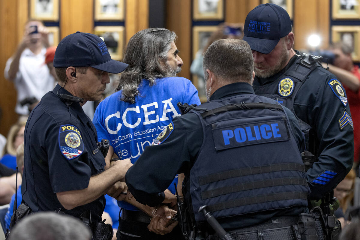 Aramis Bacallao, a teacher at Ernest A. Becker Middle School, is arrested and removed from a sc ...