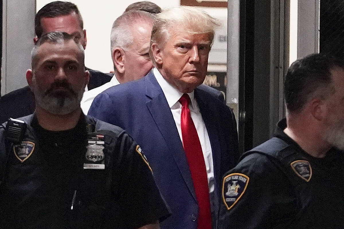 FILE - Former President Donald Trump is escorted to a courtroom, April 4, 2023, in New York. Tr ...