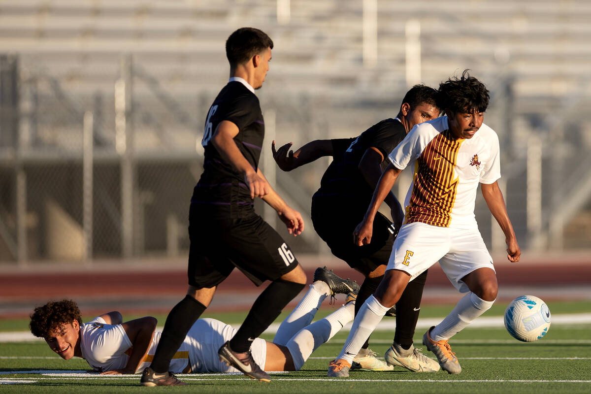 Eldorado’s Brandon Lopez, right, fights for possession of the ball after his teammate Je ...