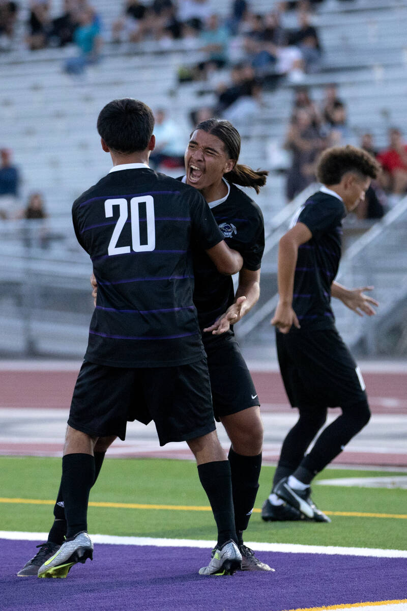 Sunrise Mountain’s Micheal Pelcastre (20) and German Alvarado Parra, center right, celeb ...