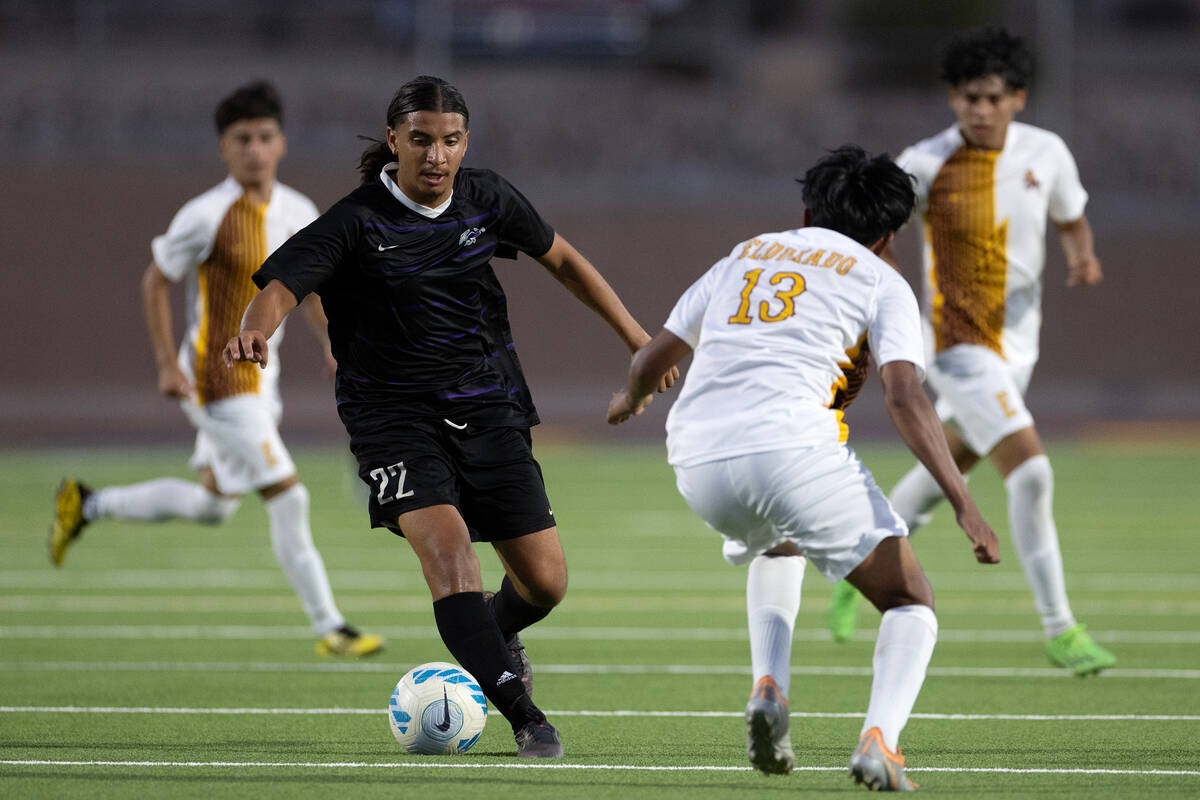 Sunrise Mountain’s German Alvarado Parra (22) dribbles against Eldorado’s Brandon ...