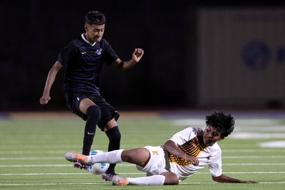 Eldorado’s Brandon Lopez, left, slide tackles Sunrise Mountain’s Jeremiah Espana- ...