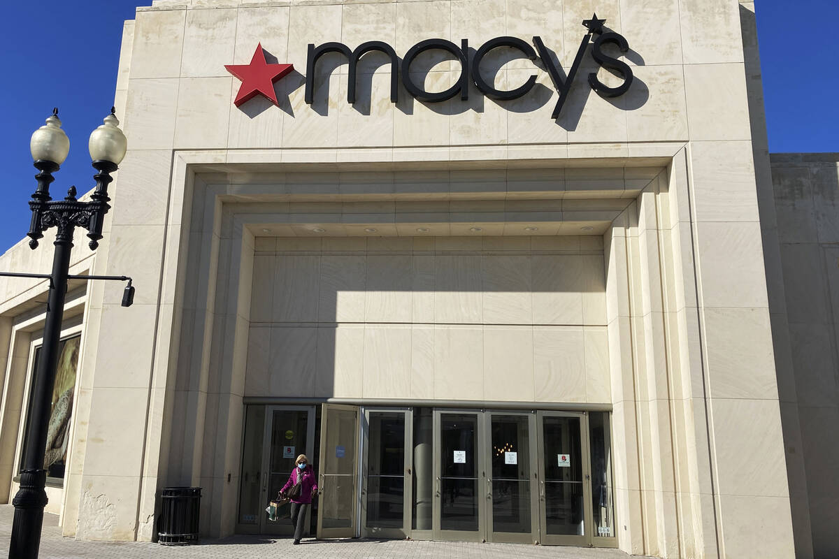 A shopper exits Macy's at the Woodfield Old Orchard Shopping Center in Skokie, Ill., Saturday, ...