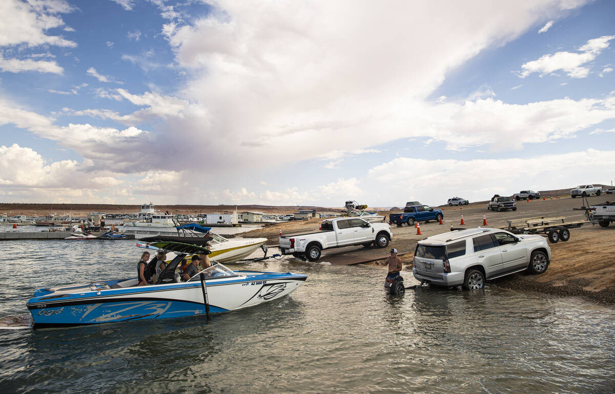 People prepare to take their boats out of the water at the Wahweap main launch ramp at Lake Pow ...