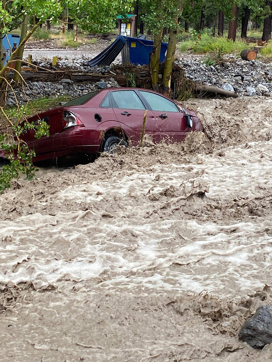 A small vehicle is swept away by Mount Charleston floodwaters on Monday, Aug. 21, 2023. (Brenda ...