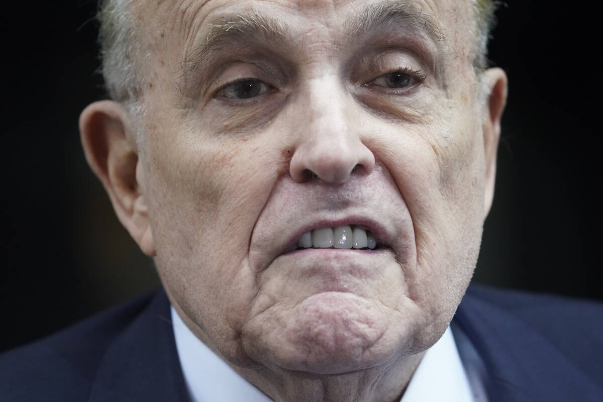 Former New York Mayor Rudy Giuliani speaks to reporters as he leaves his apartment building in ...