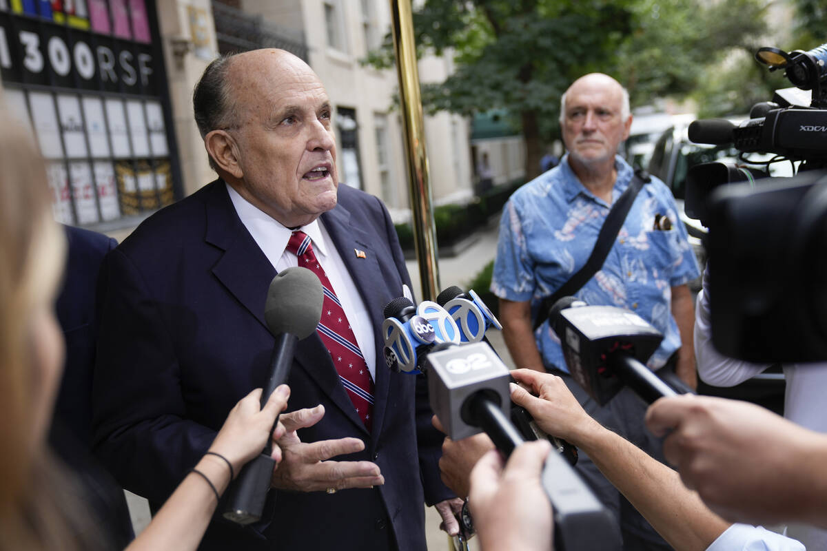 Former New York Mayor Rudy Giuliani speaks to reporters as he leaves his apartment building in ...