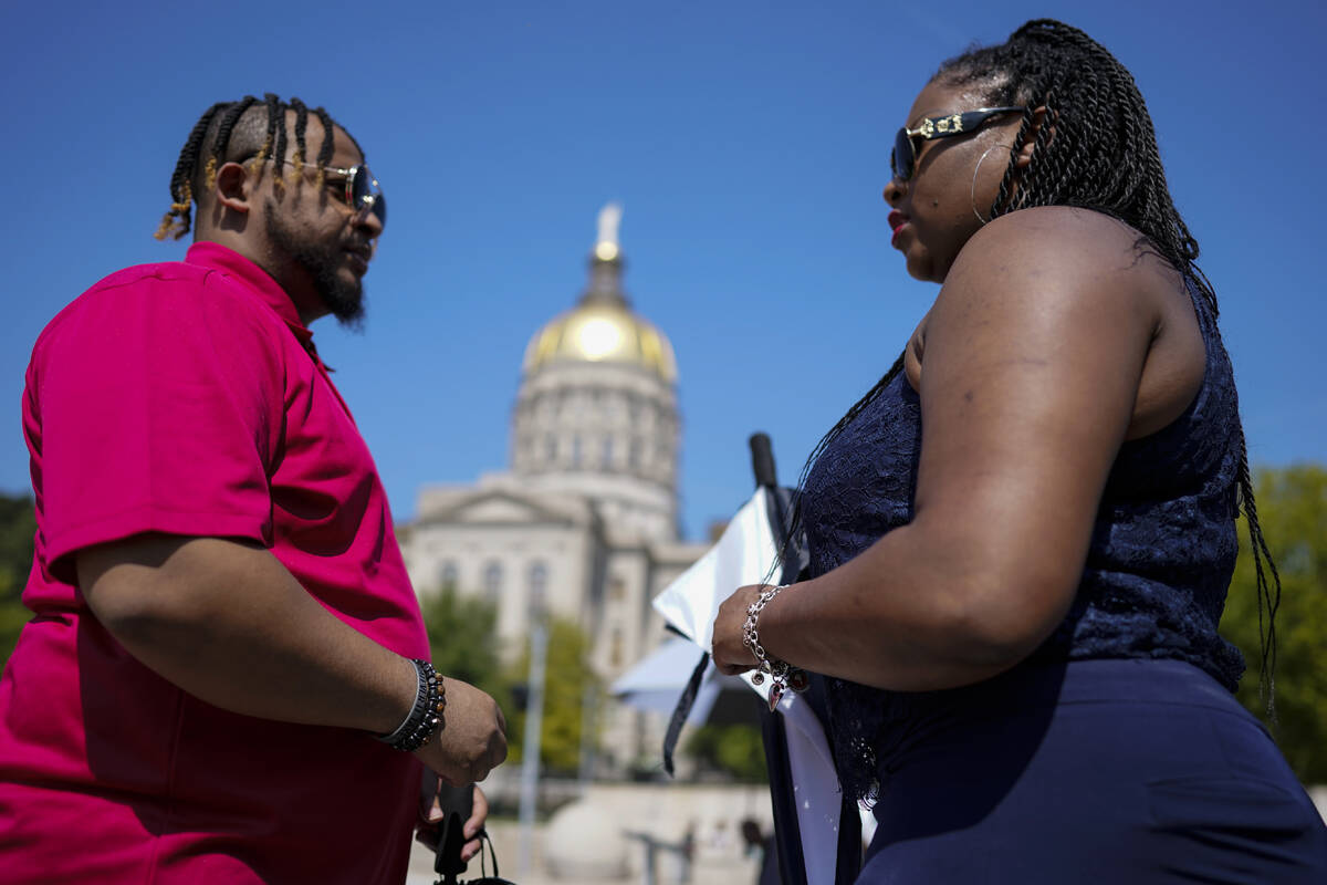 People attend a rally in support of Fulton County District Attorney Fani Willis and others insi ...