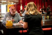Celebrity chef Jose Andres signs a copy of one his books for Sandy Tagle at his restaurant Jale ...