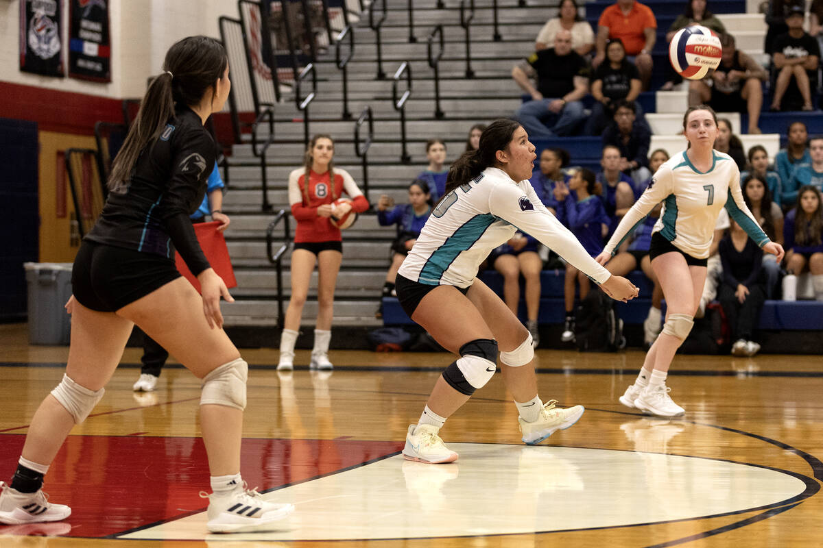 Silverado’s Kalia Roberts, center, moves to bump to Coronado during a high school volley ...