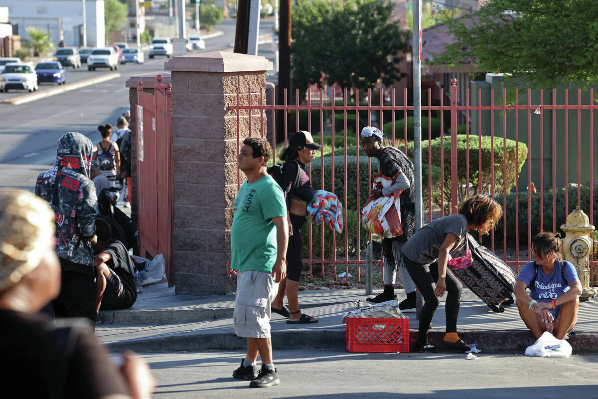People congregate on Foremaster Lane and Main Street near the Courtyard Homeless Resource Cente ...