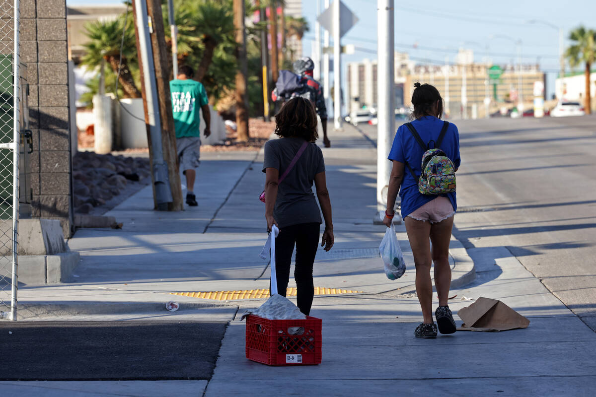 People congregate on Main Street at Foremaster Lane near the Courtyard Homeless Resource Center ...
