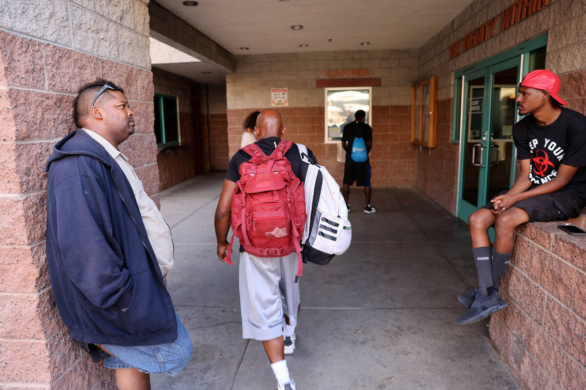 Noony Bradley, 43, left, waits to get a replacement ID at Catholic Charities Tuesday, Aug. 22, ...