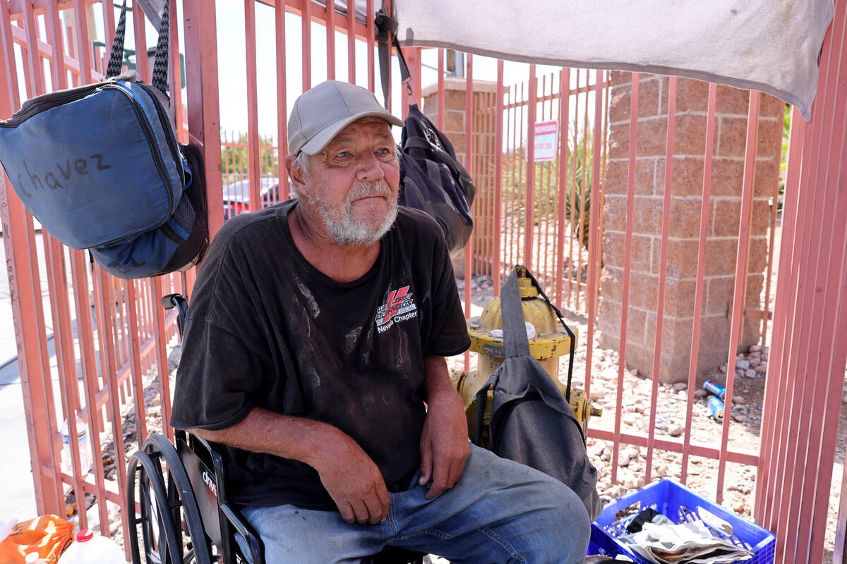 Charles Leavitt, 60, talks to a reporter under a makeshift shade structure on the corner of Las ...