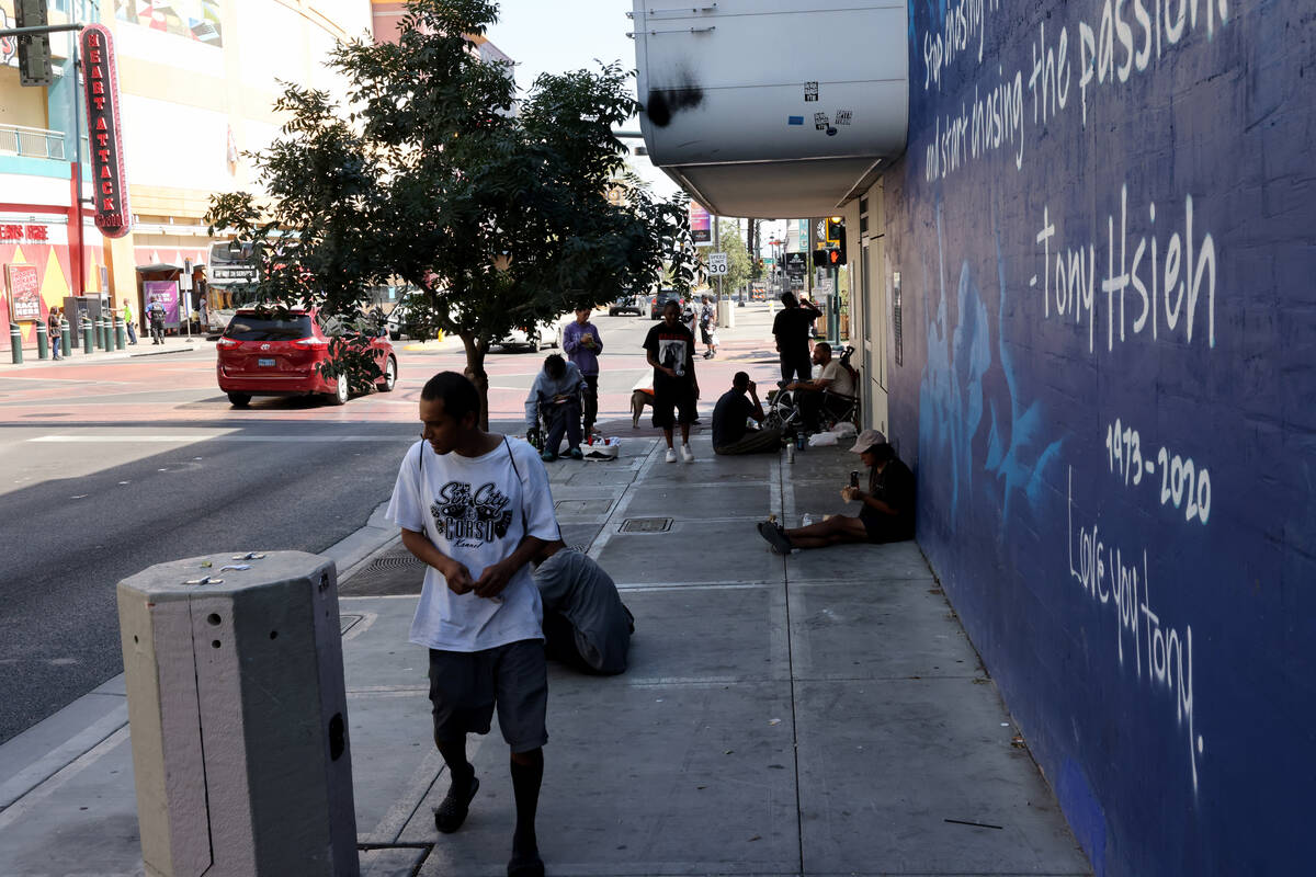 People take shelter in the shade on Las Vegas Boulevard near Fremont Street in downtown Las Veg ...