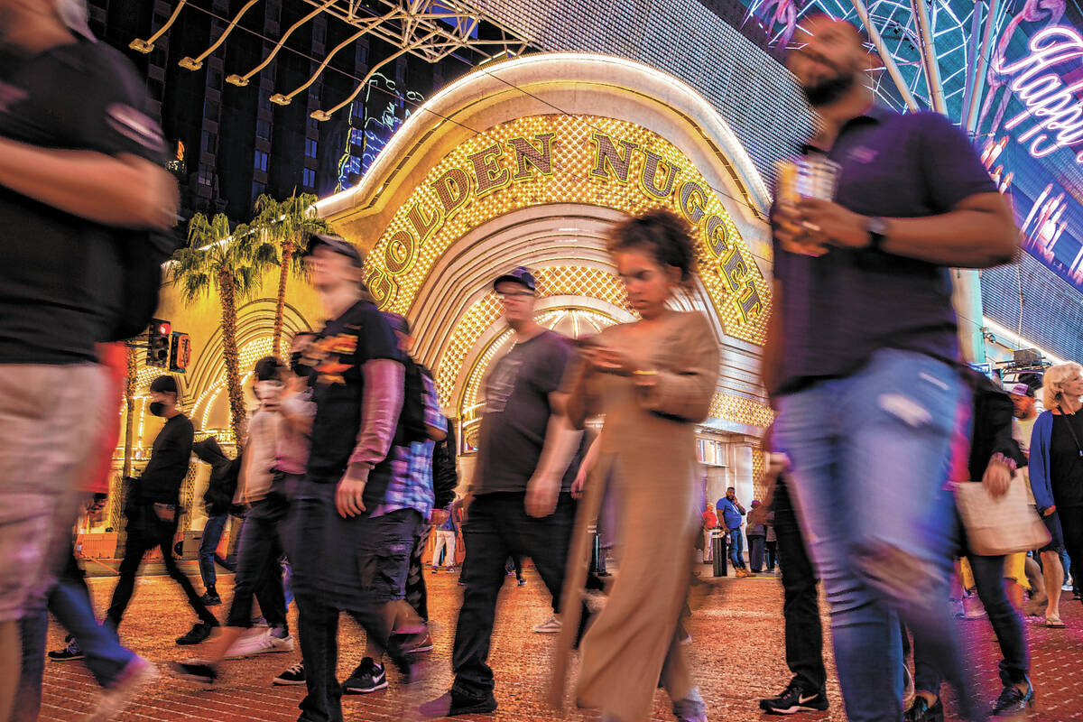 People walk past The Golden Nugget on Fremont Street on Wednesday, Oct. 20, 2021, in Las Vegas. ...