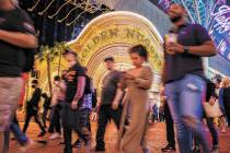 People walk past The Golden Nugget on Fremont Street on Wednesday, Oct. 20, 2021, in Las Vegas. ...