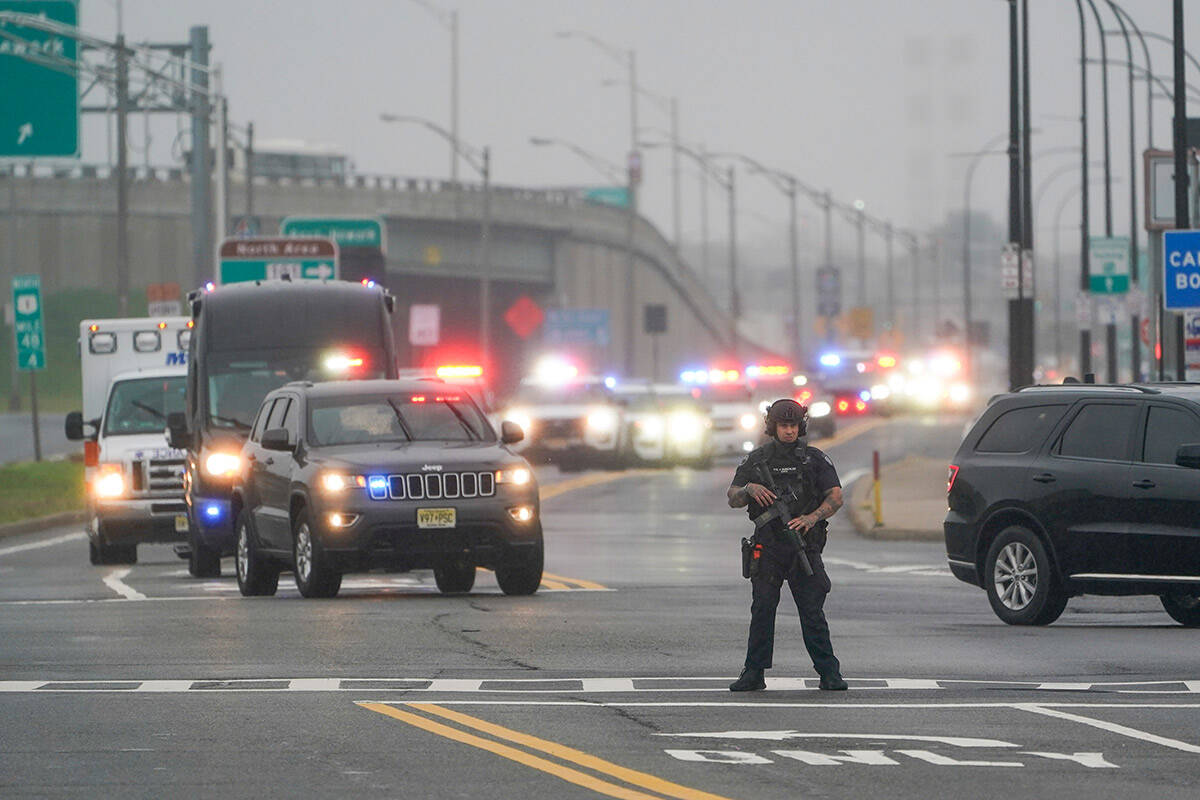 A police officers stands in the road as a motorcade for former President Donald Trump arrives t ...