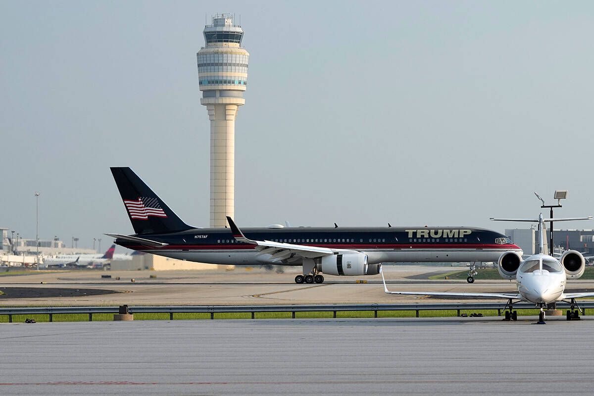 The plane carrying former President Donald Trump taxis at Hartsfield-Jackson Atlanta Internatio ...