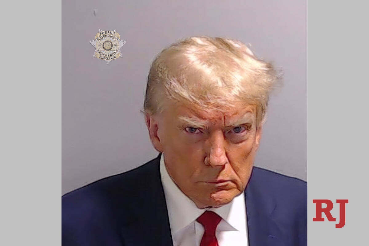This booking photo provided by Fulton County Sheriff's Office, shows former President Donald Tr ...