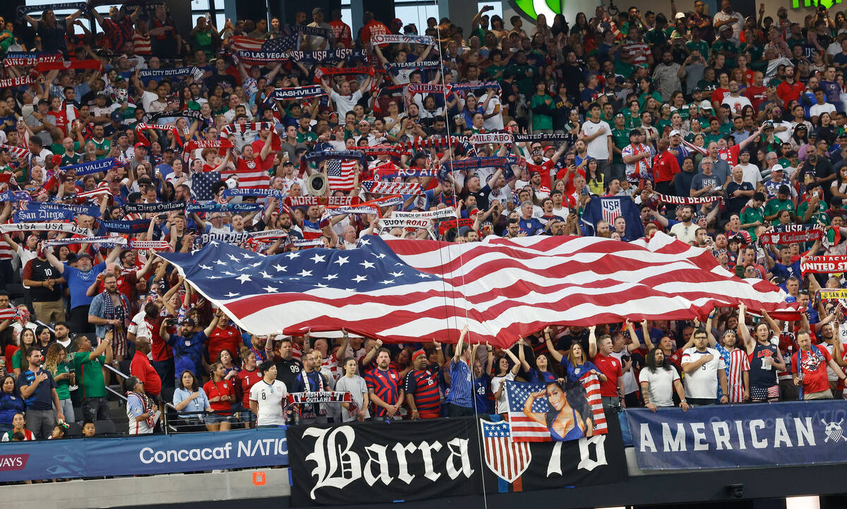 USA fans hold American flags before a CONCACAF Nations League semifinal soccer match against Me ...