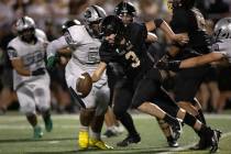 Faith Lutheran quarterback Garyt Odom runs the ball through Palo Verde’s defense during ...