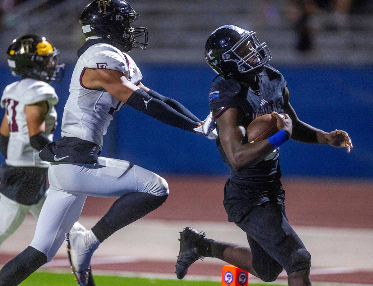 Desert Pines RB Greg Burrell (5) makes his fourth touchdown of the night past Faith Lutheran's ...