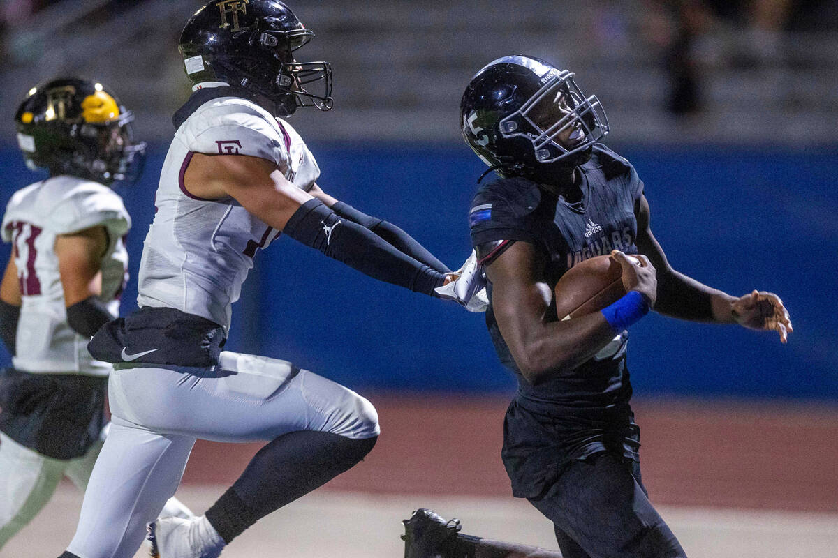 Desert Pines RB Greg Burrell (5) makes his fourth touchdown of the night past Faith Lutheran's ...