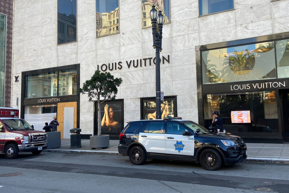FILE - Police officers and emergency crews park outside the Louis Vuitton store in San Francisc ...