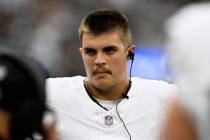 Las Vegas Raiders quarterback Aidan O'Connell looks over before a preseason NFL football game a ...