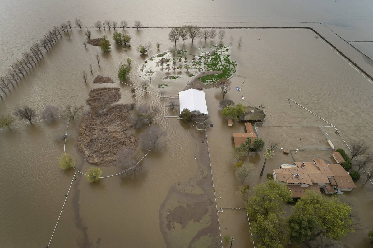 An expansive home along 6th Avenue sits in rising floodwaters after levee breaks caused extensi ...
