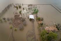An expansive home along 6th Avenue sits in rising floodwaters after levee breaks caused extensi ...