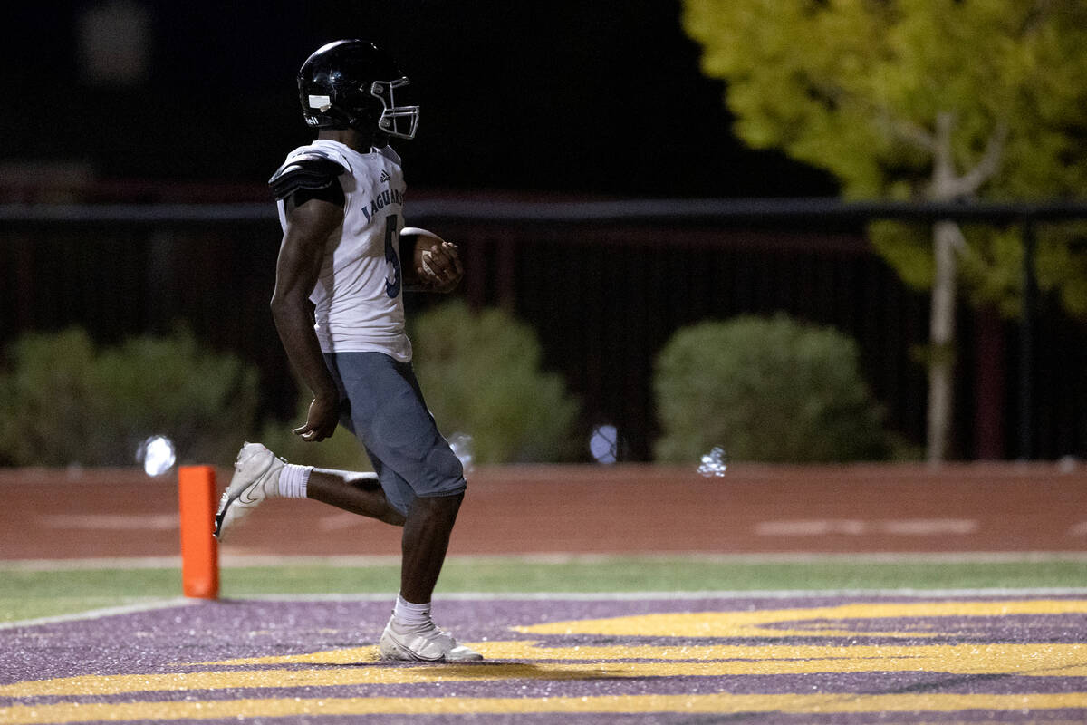 Desert Pines running back Greg Burrell (5) scores a touchdown during a high school football gam ...