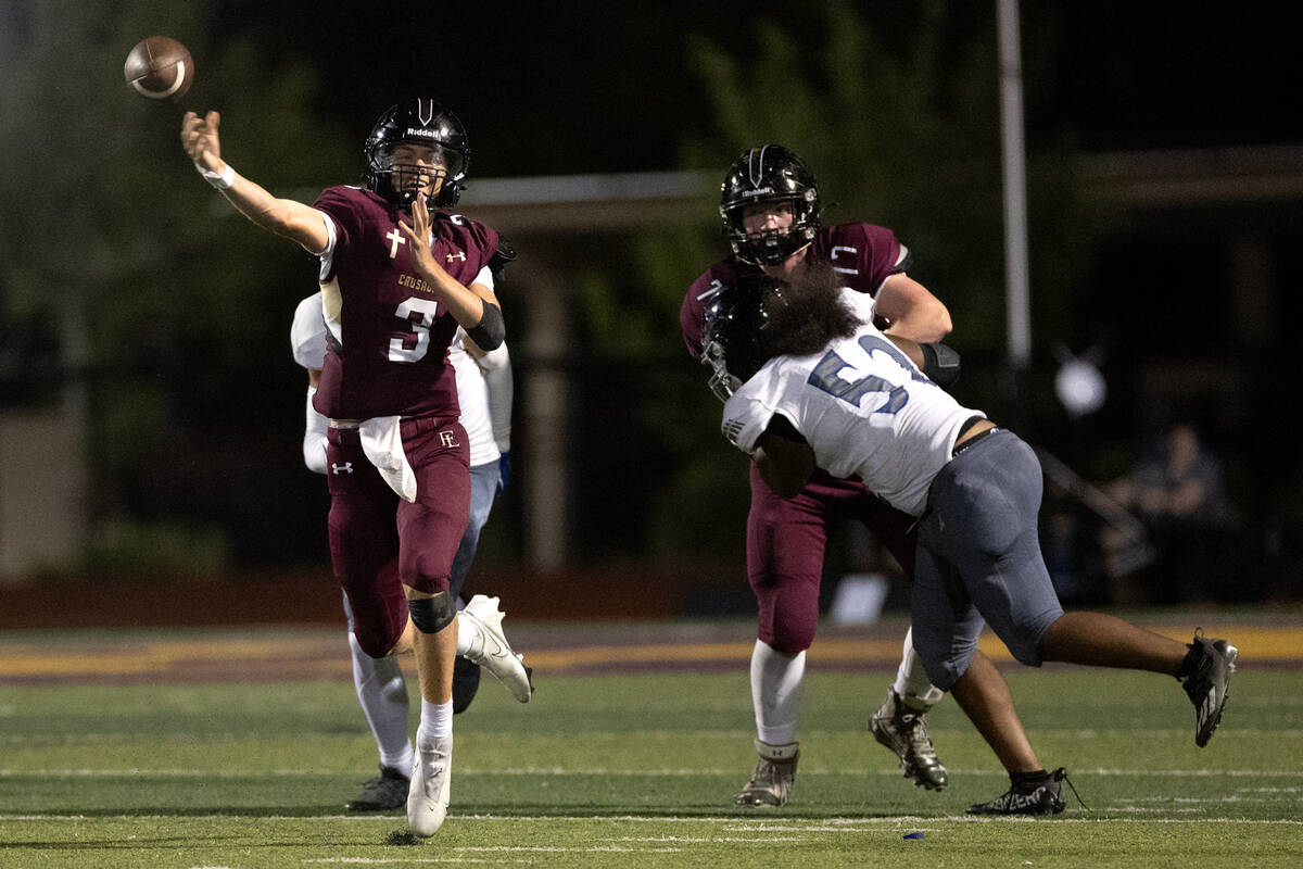 Faith Lutheran quarterback Garyt Odom (3) passes up the field during a high school football gam ...