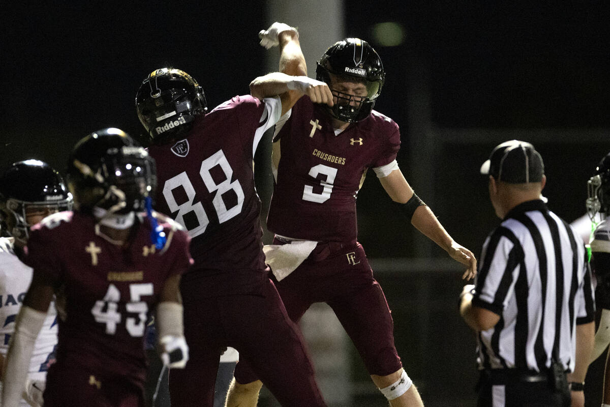 Faith Lutheran quarterback Garyt Odom (3) and tight end Cade Keith (88) celebrate Odom’s ...