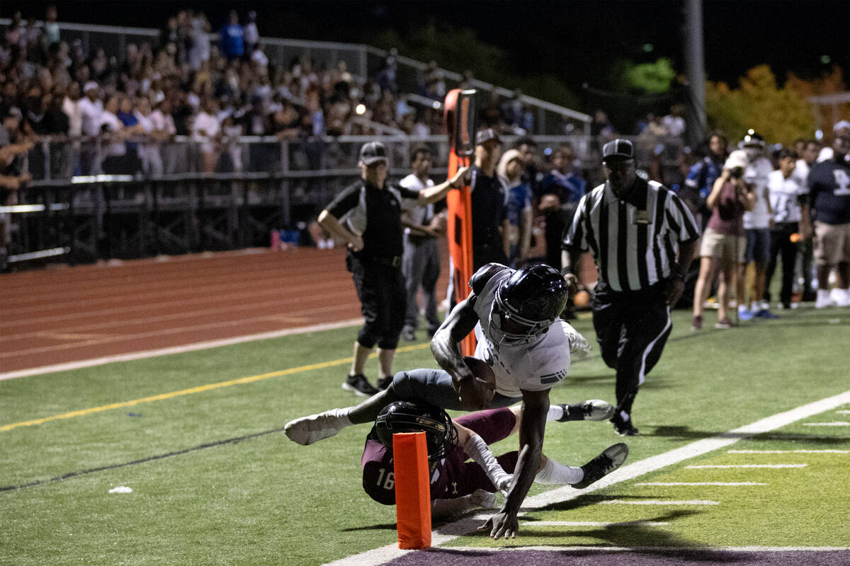 Desert Pines running back Greg Burrell (5) reaches his hand into the end zone to score a touchd ...