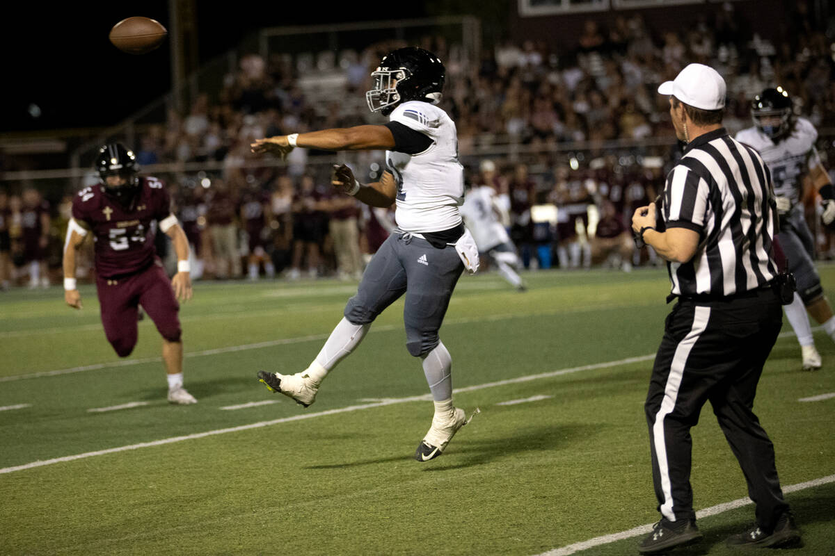 Desert Pines quarterback AJ Stowers (12) passes up the field during the second half of a high s ...