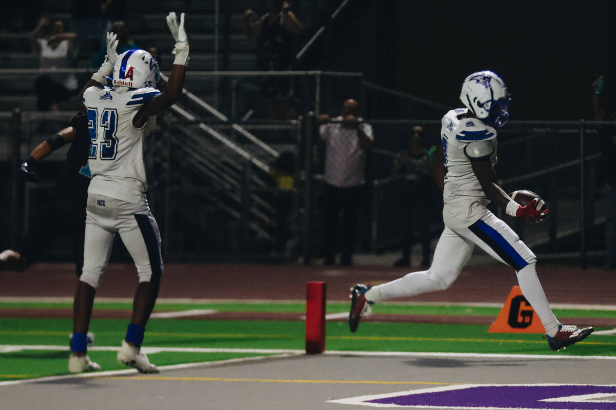 Basic wide receiver Chrey Traylor (2) makes a touchdown as his teammate, wide receiver Zuri Whi ...