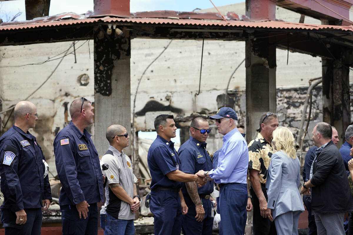 President Joe Biden and first lady Jill Biden greet first responders as they visit areas devast ...