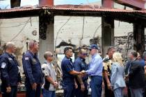 President Joe Biden and first lady Jill Biden greet first responders as they visit areas devast ...