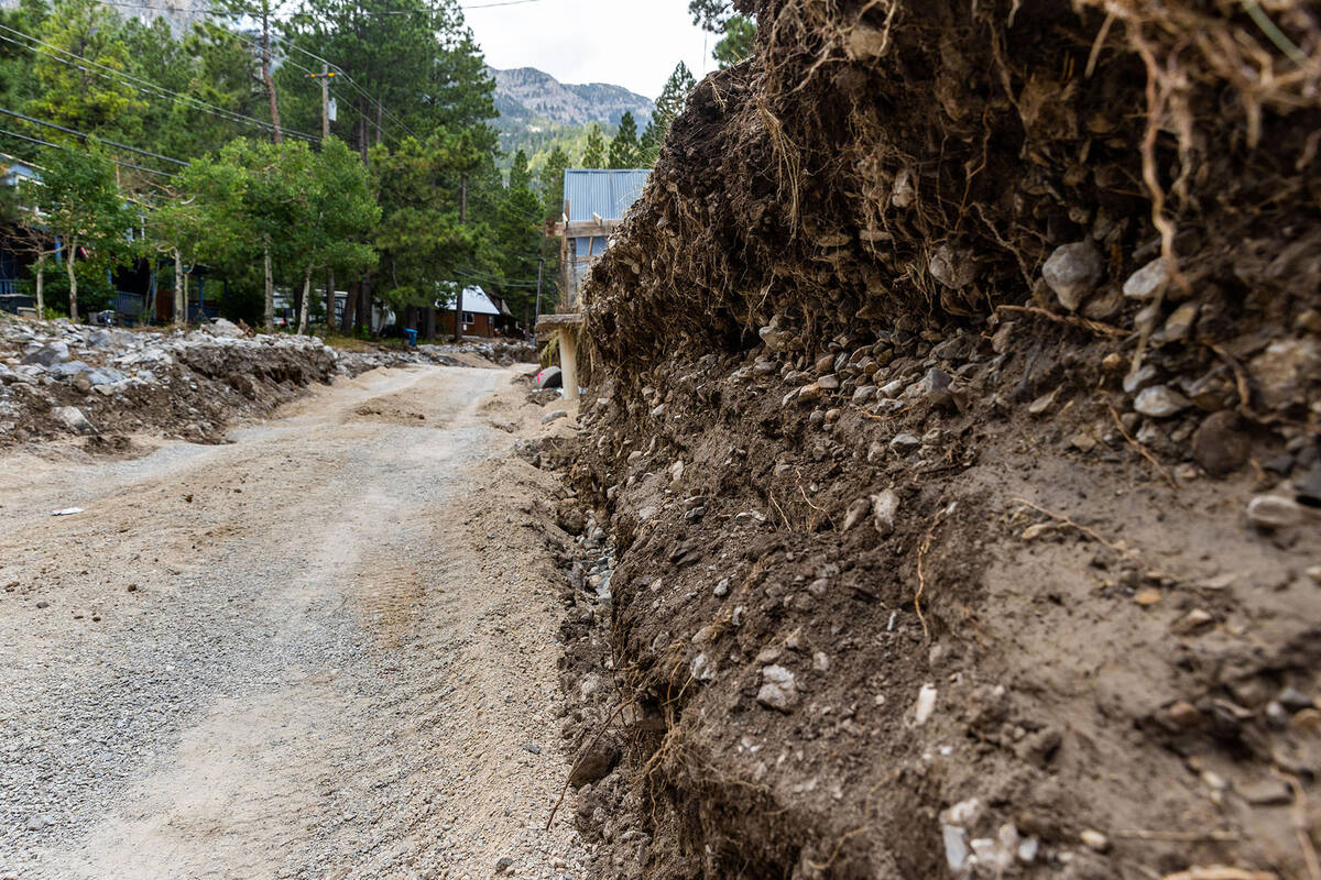 The former Aspen Avenue in Old Town has been carved away by flood waters as cleanup from the ex ...