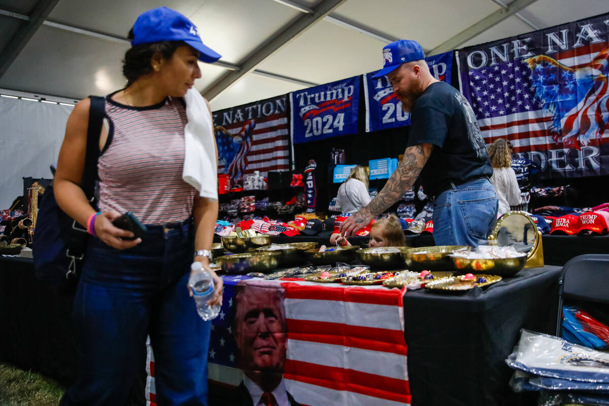 People peruse through Trump-themed merchandise at the ReAwaken America Tour on Friday, Aug. 25, ...