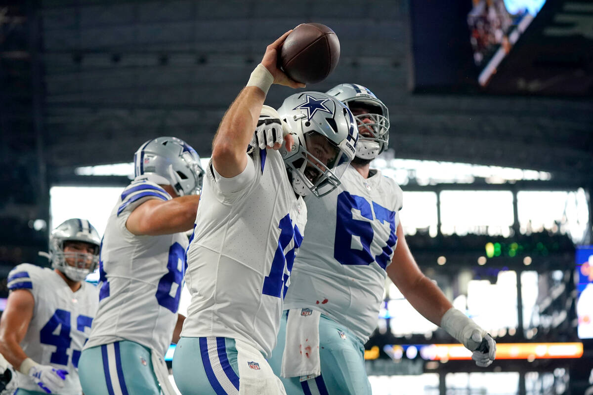 Dallas Cowboys quarterback Will Grier (15) and center Brock Hoffman (67) celebrate after Grier ...