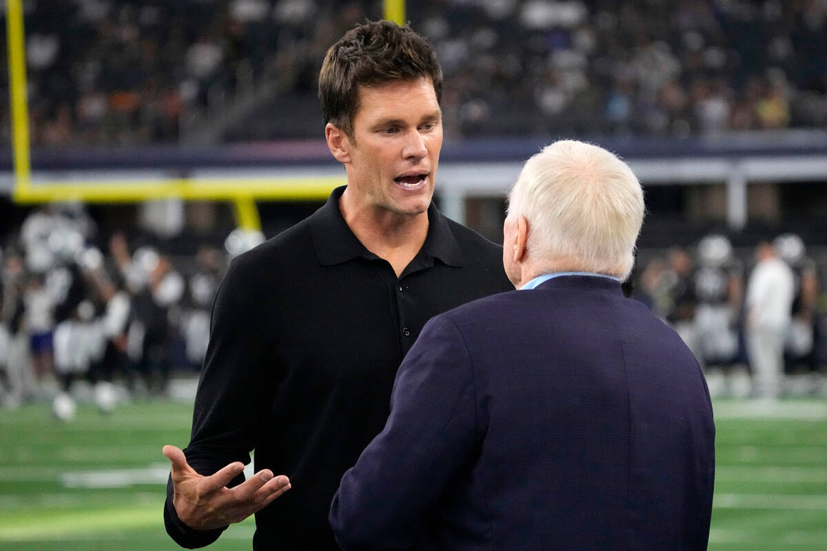 Former player, Tom Brady, left, talks with Dallas Cowboys team owner Jerry Jones, right, during ...