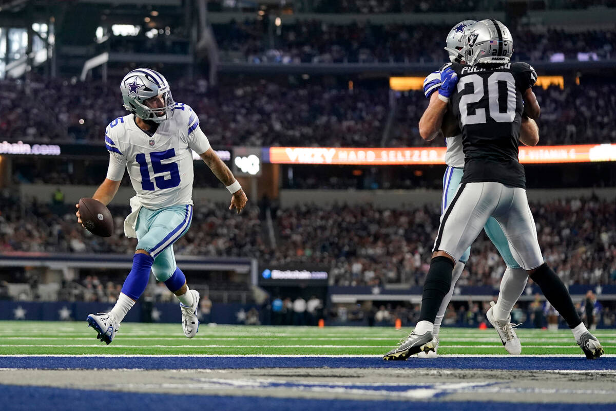 Dallas Cowboys quarterback Will Grier sprints into the end zone, past Las Vegas Raiders safety ...